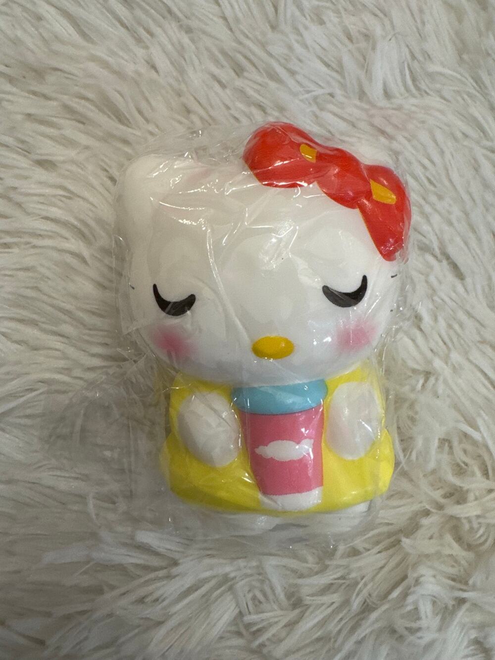 Hello Kitty foam squishy slow rebound holding a pink cup wearing a yellow dress